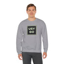 Person wearing a Heavy Blend Crewneck Sweatshirt Gildan 18000 Unisex with USYGO logo on the front. Made from 50% Cotton 50% Polyester in Sport Grey.