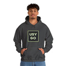 Person wearing a Heavy Blend Hoodie Gildan 18500 Unisex Jersey with big USYGO logo on the front. Made from 50% Cotton 50% Polyester in Dark Heather. Pouch pocket and the tear-away label make for a highly comfortable, scratch-free wearing.