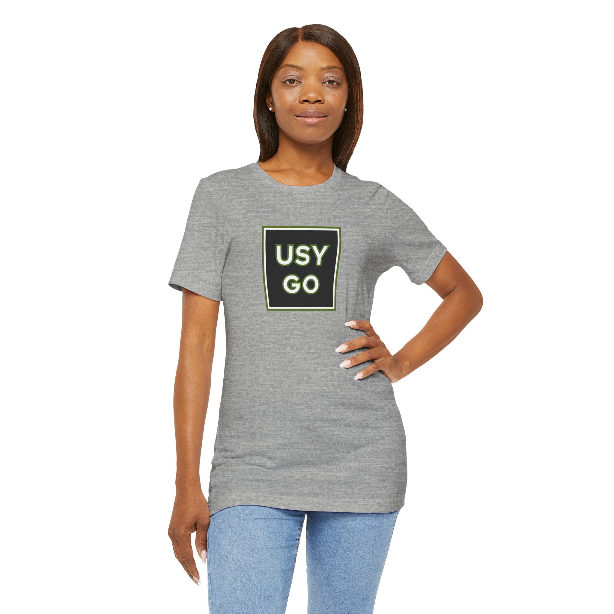 Person wearing a T-Shirt Bella+Canvas 3001 Unisex Jersey Short Sleeve Tee with USYGO logo on the front. Made from lightweight 100% Airlume combed and ring-spun cotton in Athletic Heather, ideal for active and leisure wear.