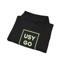 Close-up of a folded Heavy Blend Hoodie Gildan 18500 Unisex Jersey with big USYGO logo on the front. Made from 50% Cotton 50% Polyester in Black. Pouch pocket and the tear-away label make for a highly comfortable, scratch-free wearing.