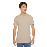 Person wearing Bella+Canvas 3001 Unisex Jersey Short Sleeve Tee with no design on the front. Made from lightweight 100% Airlume combed and ring-spun cotton in Tan, ideal for active and leisure wear.