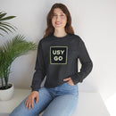 Person wearing a Heavy Blend Crewneck Sweatshirt Gildan 18000 Unisex with USYGO logo on the front. Made from 50% Cotton 50% Polyester in Dark Heather.