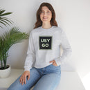 Person wearing a Heavy Blend Crewneck Sweatshirt Gildan 18000 Unisex with USYGO logo on the front. Made from 50% Cotton 50% Polyester in Ash.