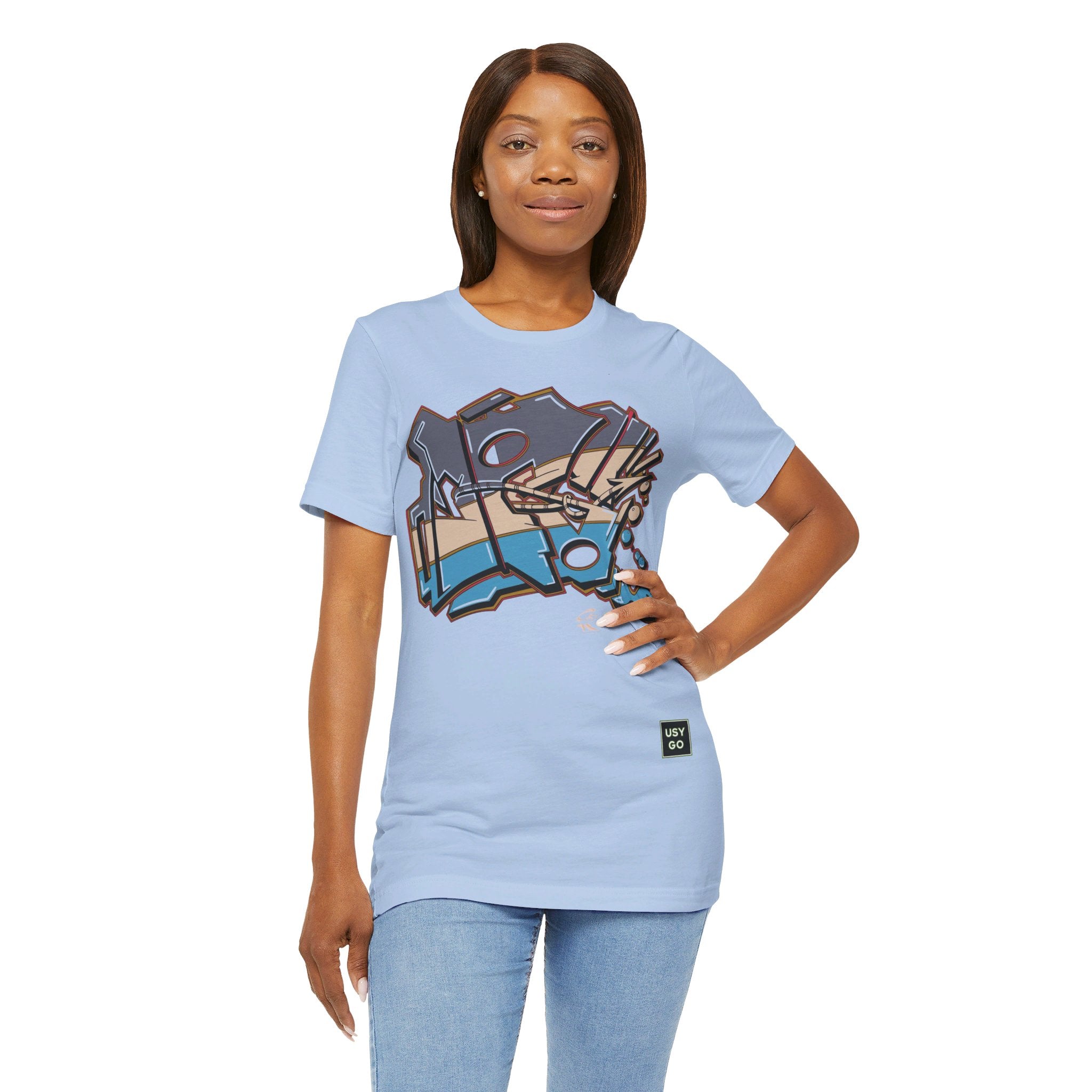 Person wearing Bella+Canvas 3001 Unisex Jersey Short Sleeve Tee with JG Fish Graffiti design on the front. Made from lightweight 100% Airlume combed and ring-spun cotton in Baby blue, ideal for active and leisure wear.