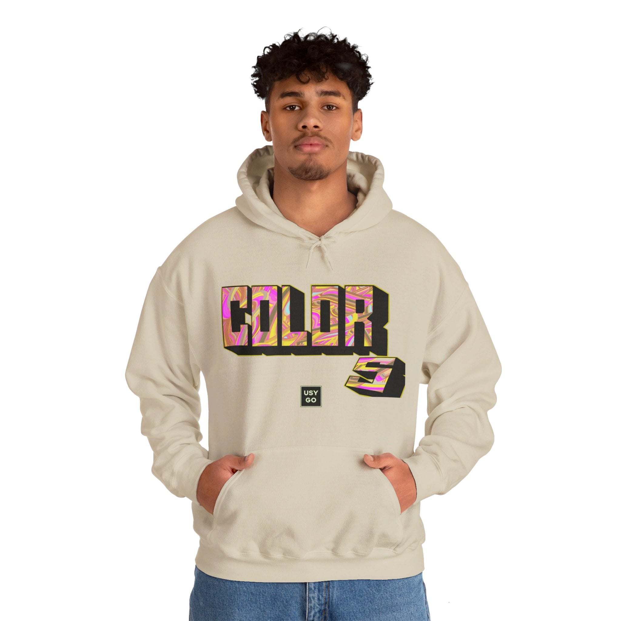 Person wearing a Heavy Blend Hoodie Gildan 18500 Unisex Jersey with Colors design by @johnnygraff31 printed on the front. Made from 50% Cotton 50% Polyester in Sand. Pouch pocket and the tear-away label make for a highly comfortable