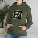 Person wearing a Heavy Blend Hoodie Gildan 18500 Unisex Jersey with big USYGO logo on the front. Made from 50% Cotton 50% Polyester in Military Green. Pouch pocket and the tear-away label make for a highly comfortable, scratch-free wearing.