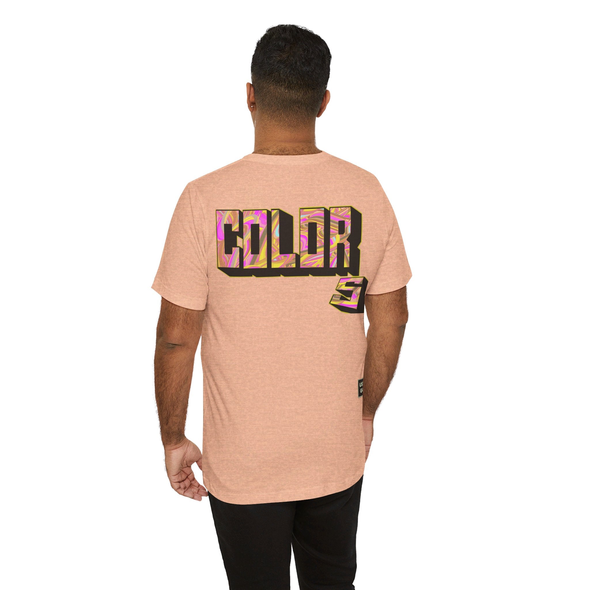 Person wearing Bella+Canvas 3001 Unisex Jersey Short Sleeve Tee with Graffiti Colors design by @johnnygraff31 on the back. Made from lightweight 100% Airlume combed and ring-spun cotton in Heather Peach, ideal for active and leisure wear.