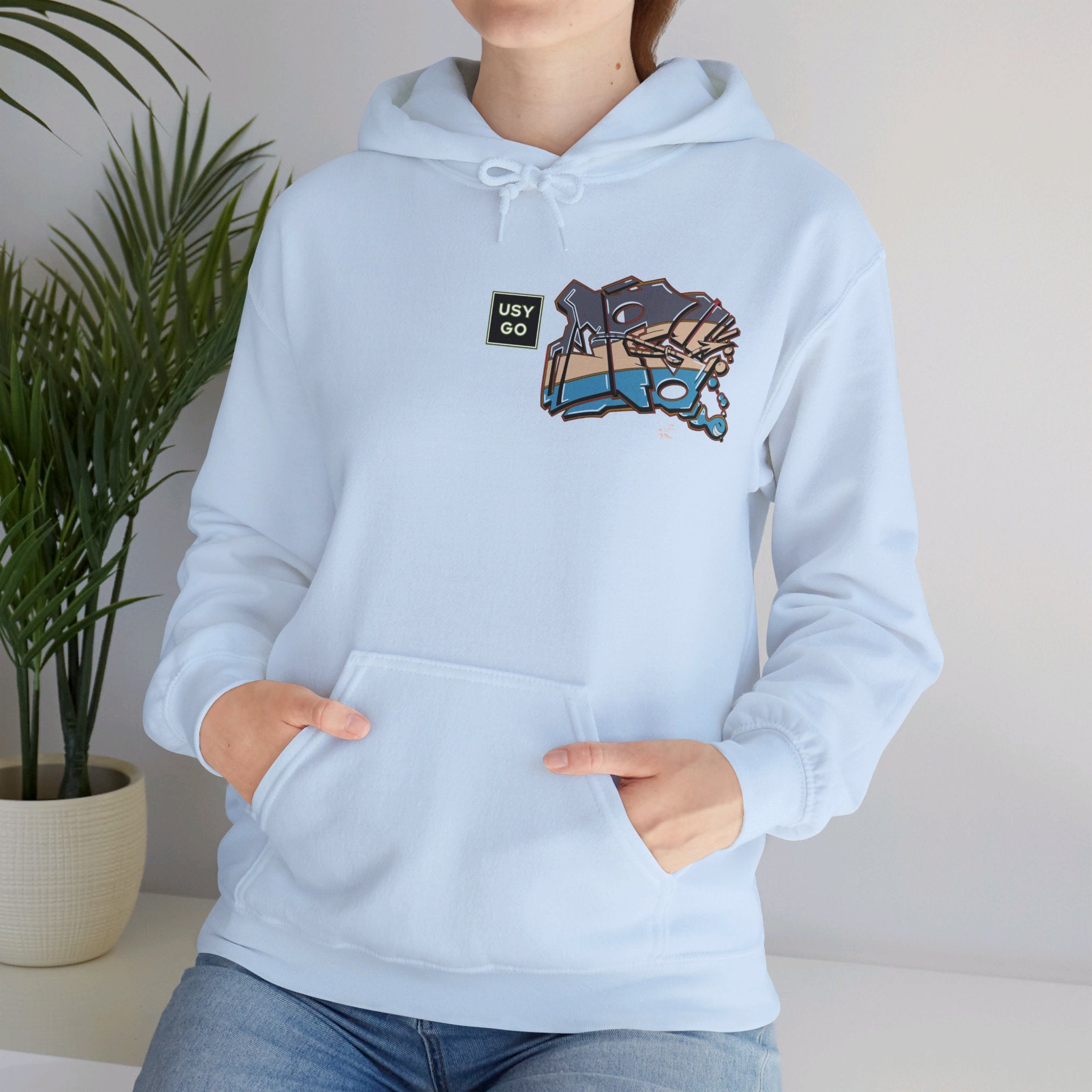 Person wearing a Heavy Blend Hoodie Gildan 18500 Unisex Jersey with JG Fish design by @johnnygraff31 printed on the front. Made from 50% Cotton 50% Polyester in Light Blue. Pouch pocket and the tear-away label make for a highly comfortable