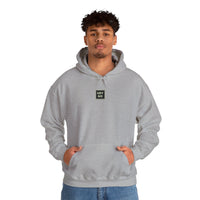 Person wearing a Heavy Blend Hoodie Gildan 18500 Unisex Jersey with USYGO logo on the front. Made from 50% Cotton 50% Polyester in Sport Grey. Pouch pocket and the tear-away label make for a highly comfortable, scratch-free wearing.